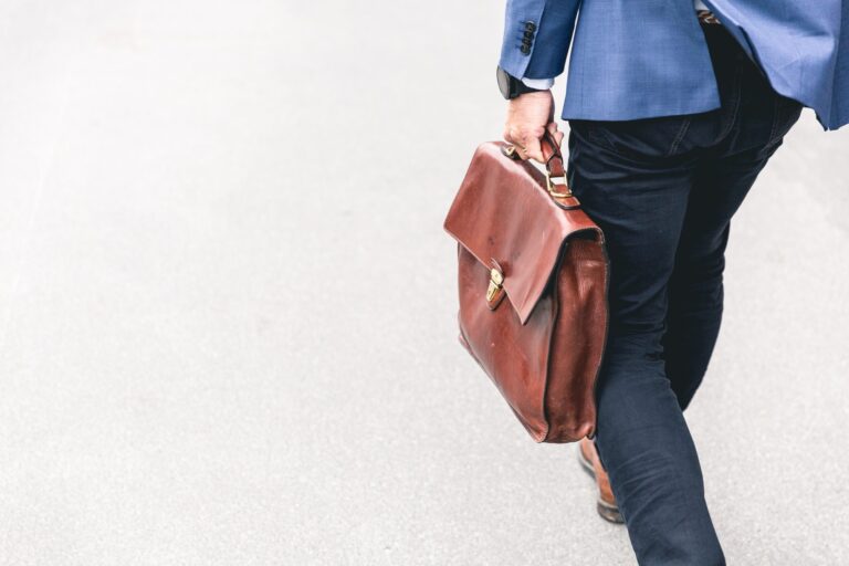 A man holding a briefcase walking to a work meeting